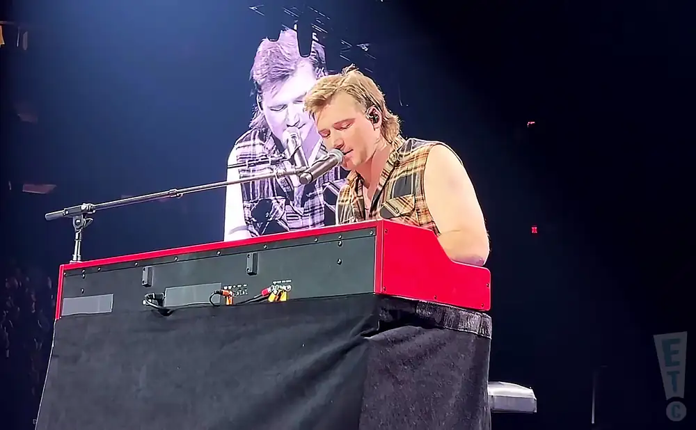 morgan wallen playing the keyboard on stage in new york city.